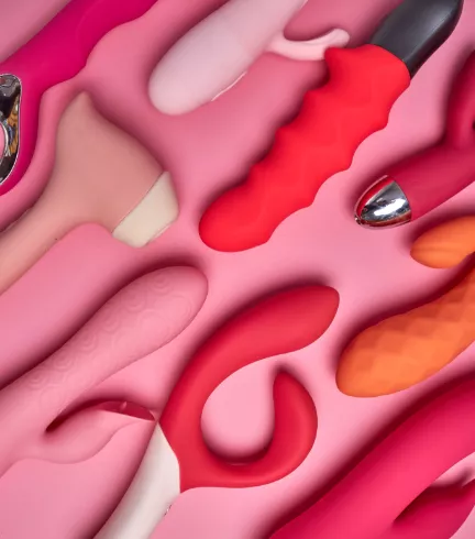 colorful vibrators arranged on pink background